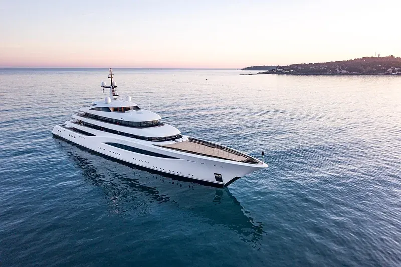 Large luxury yacht on calm water at sunset Large luxury yacht on calm water at sunset