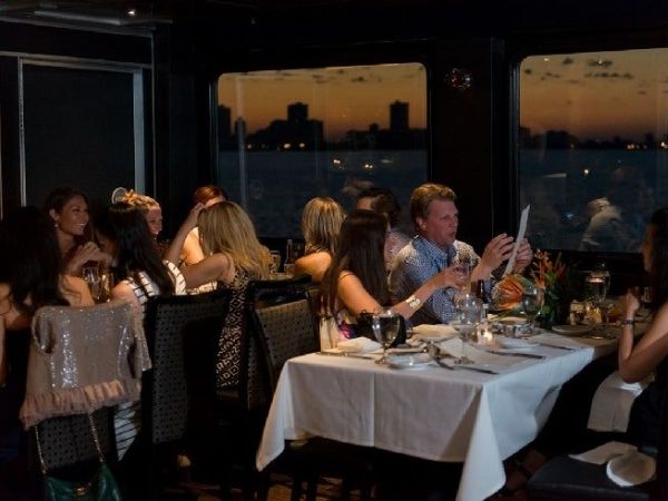 Guests enjoying dinner cruise New York Harbor